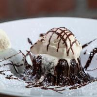 Torta Di Cioccolato · Warm Chocolate Soufflé Cake topped with Vanilla Bean Gelato and chocolate syrup.