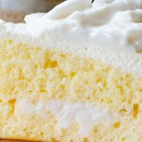 Coconut Whiteout Cake · Three layers of light, fluffy white cake are separated with apricot marmalade and creamy van...