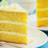Lemon Cake · Three layers of moist lemon cake topped with lemon cream custard covered with cream cheese f...
