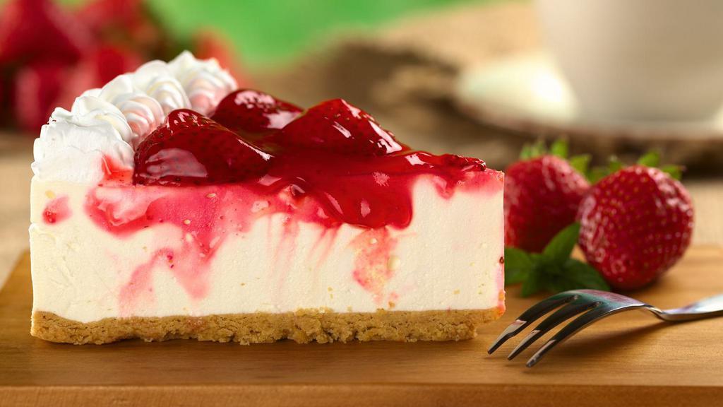 Strawberry Cheesecake · Classic cheesecake with a rich, dense, smooth, and creamy consistency topped with a delicious strawberry.