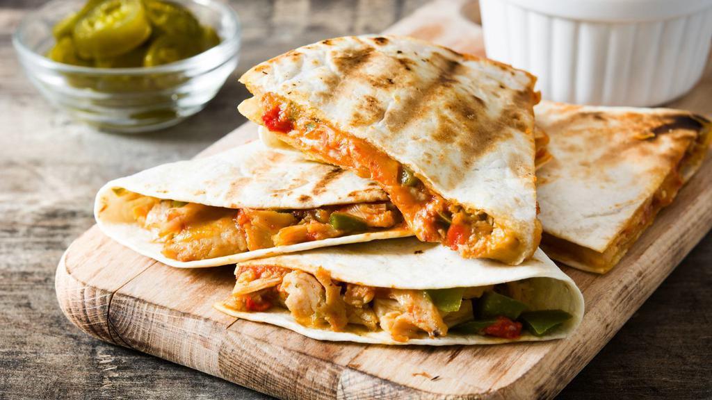 Grilled Chicken Quesadilla · A large handmade flour tortilla stuffed with grilled chicken, a blend of melted cheese, and pico de gallo. Served with a choice of sour cream or salsa.