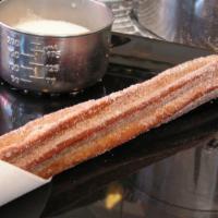Authentic Handmade Churro · A hand-twisted dessert that’s crispy outside and doughy inside, dusted with cinnamon sugar.