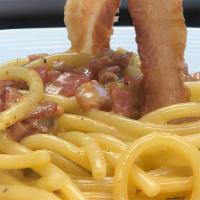 Spaghetti Alla Carbonara · Organic egg, crispy pancetta, and Sardinian pecorino.