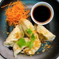 Dumplings · Steamed wontons stuffed with seasoned ground chicken. Served with dumpling sauce.