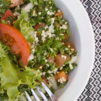 Taboule Salad · Finely chopped parsley, onions, tomato, crushed wheat bulgur mixed with olive oil and lemon ...