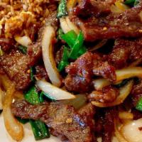 Mongolian Beef · Tender beef stir-fried with green onions and served on a bed of rice noodle.