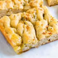 Focaccia Garlic Bread · Housemade focaccia with our garlic herb butter.