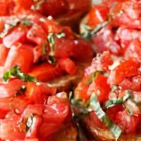 Bruschetta · Crostini with arugula, marinated tomatoes & balsamic olive oil.
