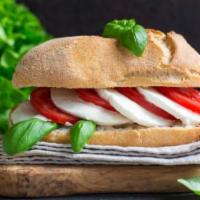 Panino Caprese · Fresh imported mozzarella, sliced tomato, roasted bell peppers and basil pesto on a toasted ...
