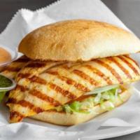 Grilled Chicken Sandwich · Juicy grilled chicken breast, lettuce, tomato, onion, roasted garlic aioli, on a toasted Fre...