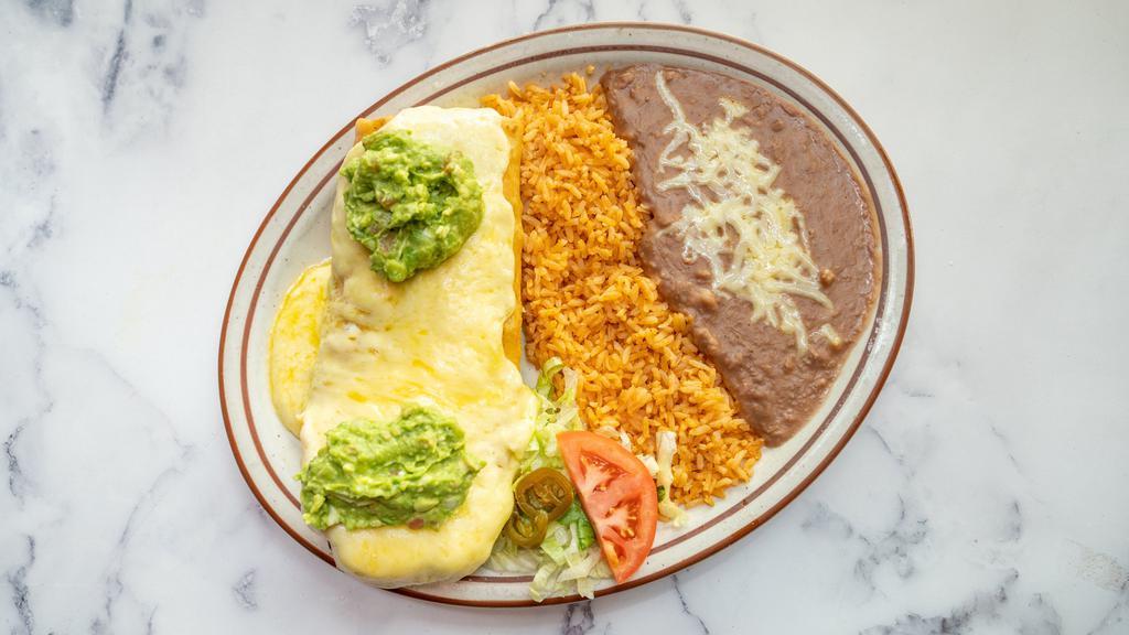 Chimichanga · One tortilla deep fried, filled with your choice of shredded beef or chicken. Covered with cheese sauce. Served with rice, beans, lettuce, guacamole, sour cream and pico de gallo.