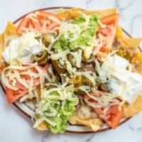 Nachos (Grande) · More of above, plus shredded beef, sour cream, guacamole, tomatoes and jalapeno peppers.