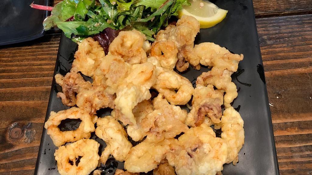 Tempura Calamari · Deep fried marinated calamari, lemon zest, lemon wedge, garlic aioli.
