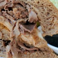 French Dip · Tender-rare roast beef served on a french roll complimented with hot au jus. Served with cur...