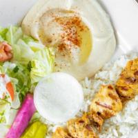 Grilled Chicken Skewer Meal · Grilled chicken skewers marinated with garlic and herbs. Served with rice, salad, pita bread...
