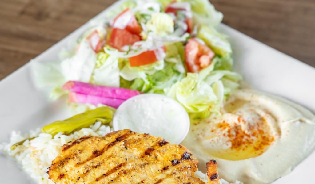 Grilled Chicken Breast Meal · Grilled boneless, skinless chicken breasts marinated with garlic, and herbs. Served with rice, salad, pita bread, and garlic sauce.