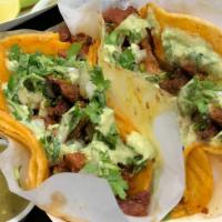 Adobada - Taco · Corn tortilla filled with marinated pork, guacamole cream, cilantro and onion.