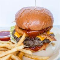 The Western Burger · Cheddar cheese, bacon, onion rings, BBQ sauce, lettuce, and tomato.
