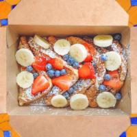 French Toast* · Sweet egg brad topped with bananas, berries and whipped cream. Maple syrup and butter on the...
