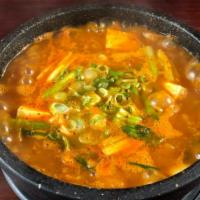 Kimchi Jjigae · Aged kimchi and pork stew with tofu and scallions.