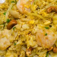 Pineapple Curry Fried Rice · Chicken, shrimp, peas, carrots, white onions and cashews tossed with fried rice, spiced with...