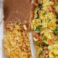 Huevos A La Mexicana · Two eggs scrambled with tomatoes, onions and jalapenos (spicy) served with spanish rice, ref...
