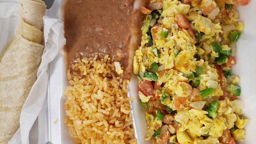 Huevos A La Mexicana · Two eggs scrambled with tomatoes, onions and jalapenos (spicy) served with spanish rice, refried beans and tortillas