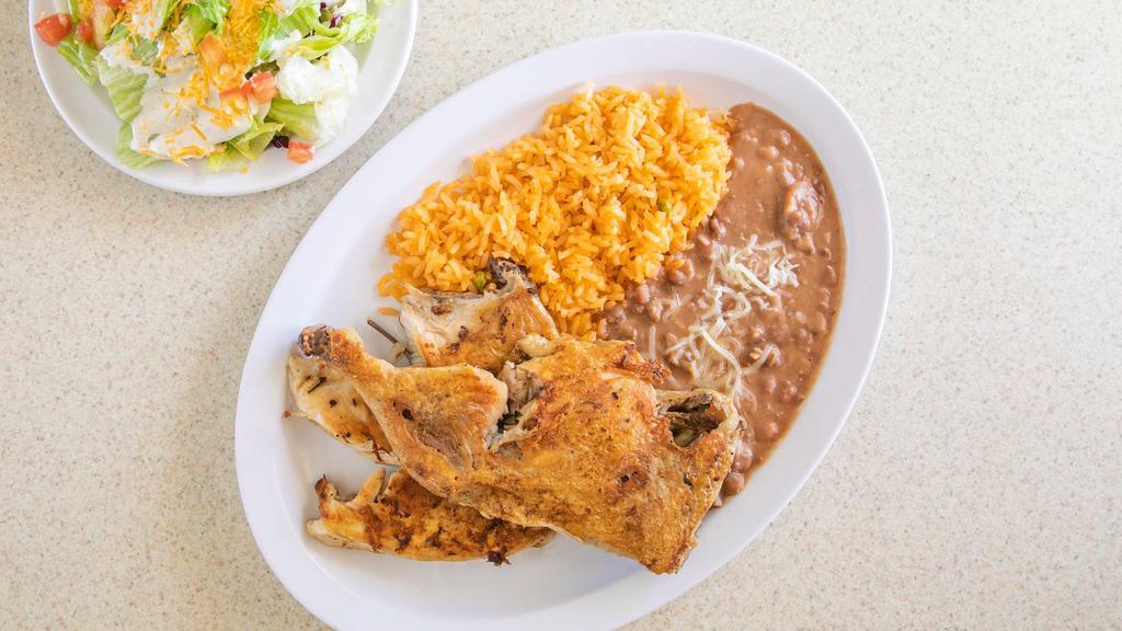 Pollo Asado · Half grilled chicken with French fries, salad, and tortillas.