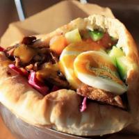 Sabich · This traditional vegetarian dish served with fried eggplant and a hard-boiled egg.

Plate / ...