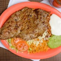 Carne Asada · Two grilled thin sirloin steaks. rice beans sour cream guacamole lettuce and tomato.