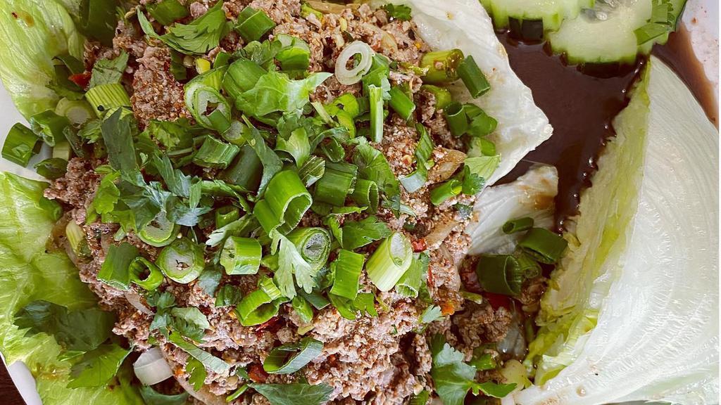 Larb Chicken Or Beef · Minced beef or chicken, crushed Thai chili, mint, cilantro, green onions, served with slices of cucumbers and cabbage