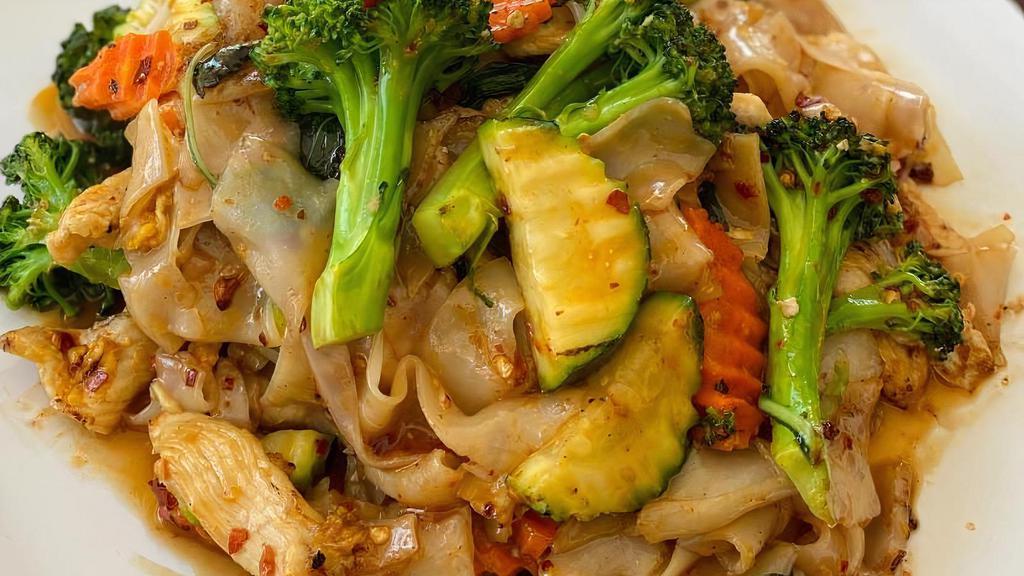 Pad Kee Mao · Spicy pan fried wide rice noodles, broccoli, carrots, basil, bell peppers, zucchini, and green beans. Please specify your meat choice, chicken or pork or beef.