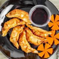 Pot Stickers · Chicken Pot Stickers served with house sauce.
