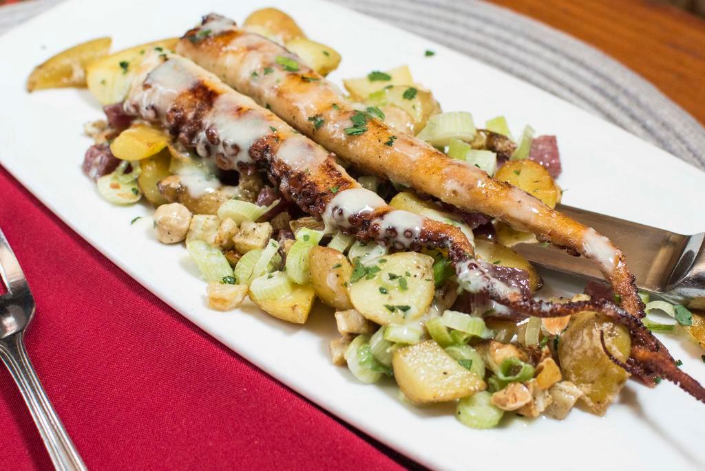 Polpo Con Rafano · Gluten-free. Seared octopus, warm fingerling potato salad, celery root, Marcona almonds, finocchiona, horseradish aioli.