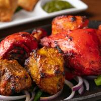 Mixed Tandoori Sizzler · An assortment of tandoori specialties: tandoori chicken, tandoori chicken tikka, seekh kebab...