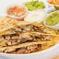 Pollo Asado · On flour tortilla with grilled chicken and side of guacamole and sour cream.