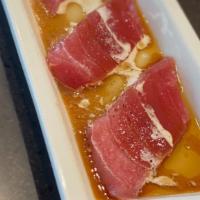 Tuna Carpaccio · Thinly sliced bluefin tuna served with special soy sauce and dash of cream.