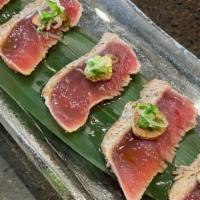 Peppered Tuna Sashimi · Thinly sliced seared tuna served with sepcial soy sauce.