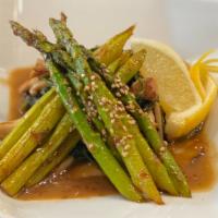 Sautéed  Spinach And Asparagus · Spinach and asparagus sautéed  in butter and soy sauce served with wild mushroom.