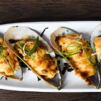 Baked Mussels · New Zealand green mussels on half shell baked with dynamite sauce