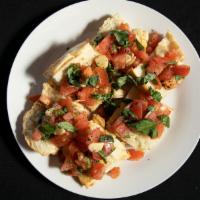 Bruschetta · Chopped tomatoes with fresh basil, fresh garlic, and pesto sauce on Italian bread