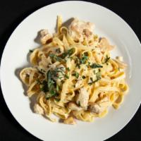 Fettuccini Alfredo · Long flat pasta tossed with tomatoes, and traditional alfredo sauce.