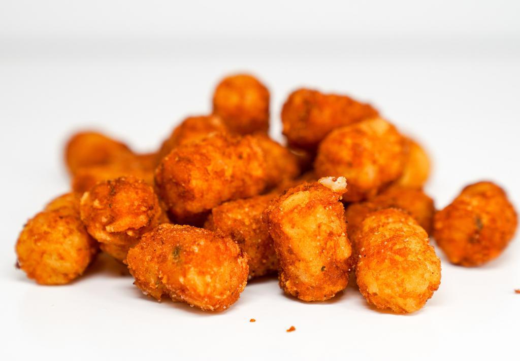 Spiced Tots · Crispy potato tots tossed in a medium heat spiced Nashville seasoning blend. Served with a side of sriracha aioli.