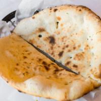Classic Naan · Teardrop-shaped, leavened bread baked in a tandoor oven