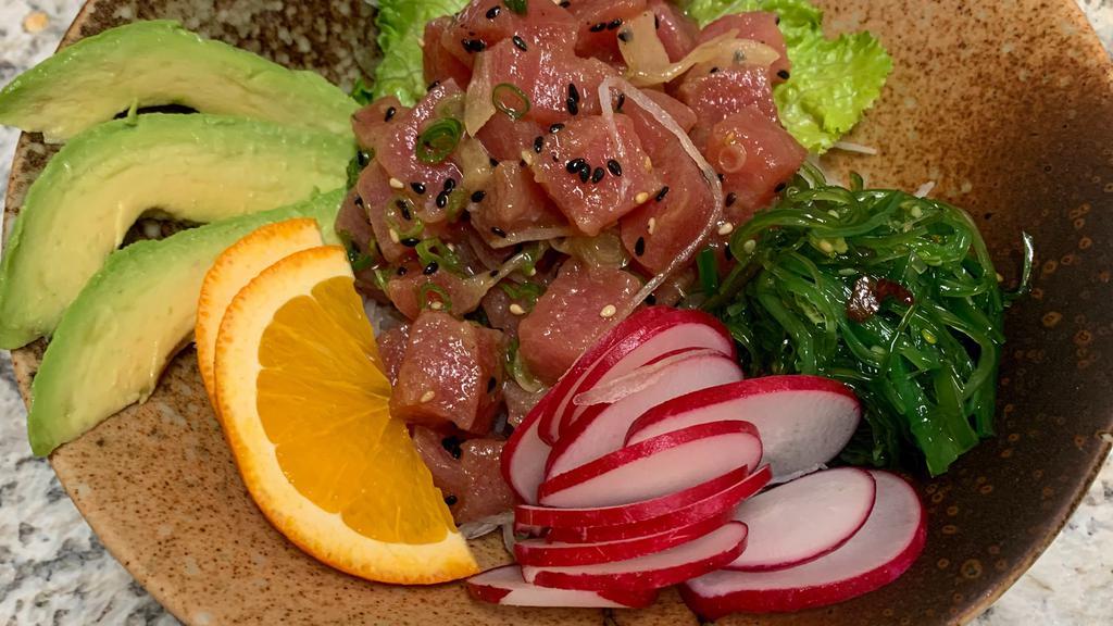 Ahi Poke Bowl* · *Served raw or undercooked or contains raw or undercooked meats, poultry, seafood, shellfish or eggs, which may increase your risk of foodborne illness, especially if you have certain medical conditions. Hawain-style ahi tuna with onions, sesame seeds, and avocado. served with rice.