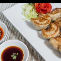 Pot Stickers · Eight pieces. Handmade pan-fried pork dumplings served with a Chef’s special sauce and homem...