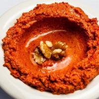 Muhammara · Ground walnuts, Aleppo pepper paste, and spices, drizzled with olive oil.