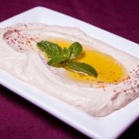 Labneh · Strained yogurt cheese, topped with red pepper powder and olive oil.