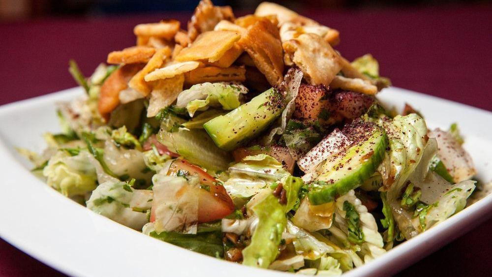 Fattoush · Lettuce, cucumber, and tomatoes tossed in a vinaigrette dressing with sumac, garlic and pita chips.