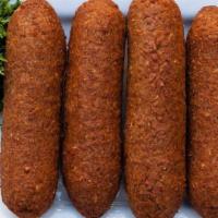 Fried Aleppo Kibbeh · Fried kibbeh shell stuffed with spiced ground meat, onions, and nuts.